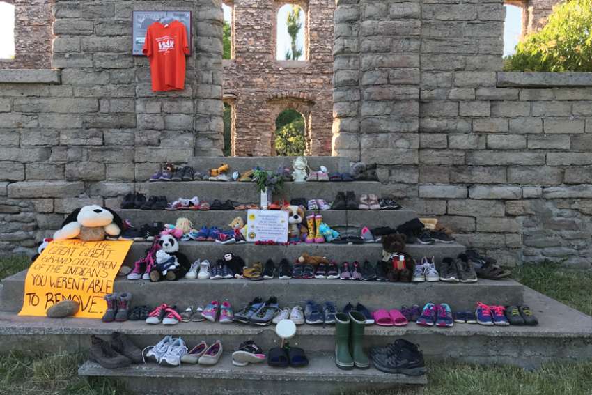Shoes and toys were laid on ruins at he old Holy Cross Church in Wiikwemkoong on Manitoulin Island.