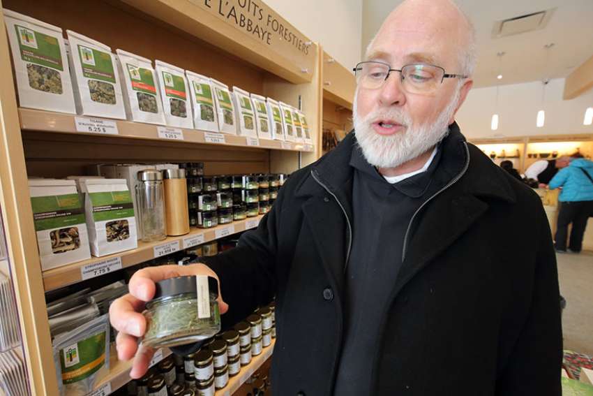 Abbot Andre Barbeau of Val Notre-Dame Cistercian abbey in Saint-Jean-de-Matha, Quebec, holds a jar of larch needles, used in salads and soups produced at the abbey and sold in its gift shop.
