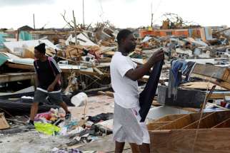 A man hangs his clothing amid the rubble of destroyed homes Sept. 6, 2019, after Hurricane Dorian hit the Abaco Islands in Marsh Harbour, Bahamas. In the wake of Hurricane Dorian&#039;s brutal blasting of the Bahamas, Catholic organizations in Florida continued to raise funds to aid victims there.