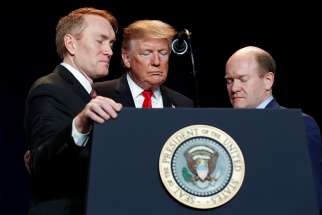 U.S. President Donald Trump joins Sens. James Lankford, R-Okla., and Chris Coons, D-Del., in prayer at the National Prayer Breakfast in Washington Feb. 7, 2019.