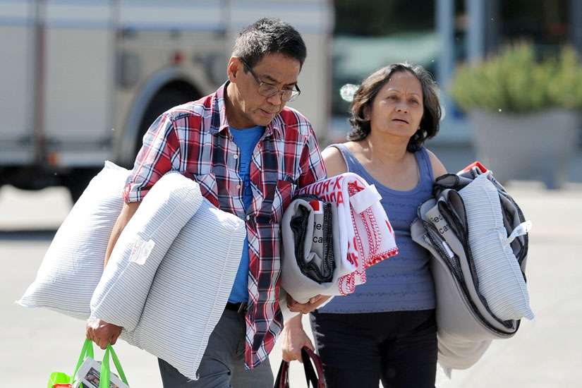 Evacuees from the Fort McMurray wildfire leave The Expo Center May 4 after receiving bedding supplies in Edmonton, Alberta. The entire population of Fort McMurray has been evacuated because of the wildfire.