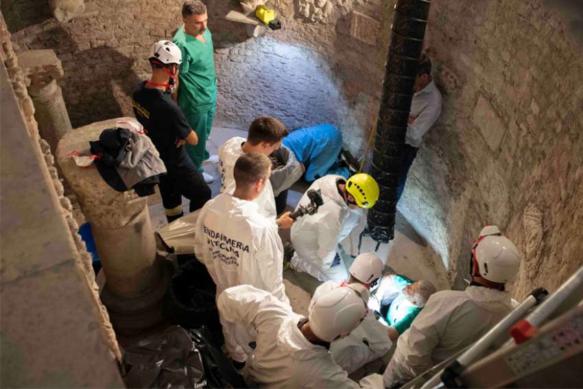 Workers inspect an ossuary at the Teutonic Cemetery at the Vatican in this July 20, 2019, file photo. The ossuary was inspected in the hope of finding the missing remains of a German princess and duchess and possibly the remains of Emanuela Orlandi, who disappeared in 1983. The Vatican prosecutor has opened a new investigation into the disappearance 40 years ago of Orlandi, the 15-year-old daughter of a Vatican employee.