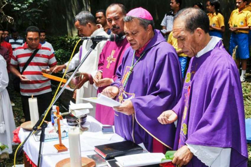 Bishop Hubertus Leteng of Ruteng, Indonesia, center, celebrates Mass in early April in Ruteng. 