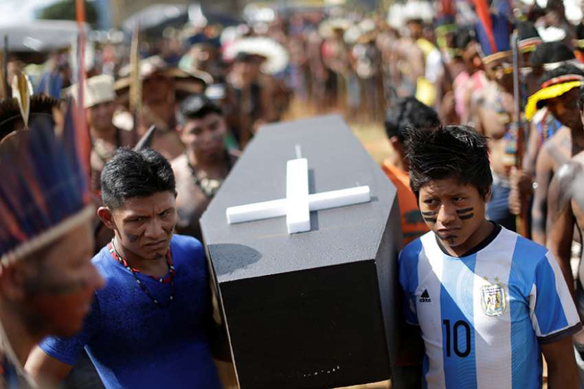 Brazilian Indians in Brasilia carry a symbolic coffin April 25 to show the death of indigenous rights in their country. The Brazilian bishops&#039; Indigenous Missionary Council criticized an April 30 attack in a remote area of Maranhao state that left 13 Gamela Indians injured.