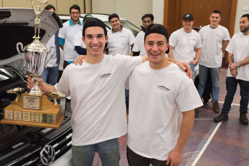 David Vecchiarelli, left, and Christopher Giuga show off the hardware they won at the Canadian International Auto Show.