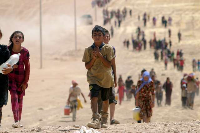 Children flee violence from forces loyal to the Islamic State in Sinjar, Iraq. Cardinal Fernando Filoni said international action is necessary to guarantee the possibility of survival in Iraq.