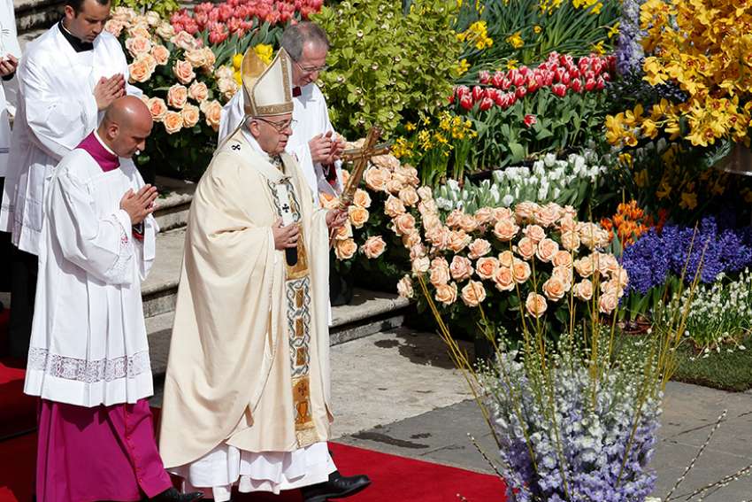 Pope Francis walks past flowers as he celebrates Easter Mass in St. Peter&#039;s Square at the Vatican April 1. 