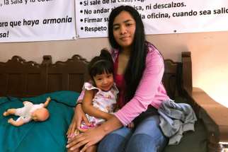 Denia Garcia poses with her daughter Diana, 2, at the Catholic-run Dignified Migrant shelter in Piedras Negras, Mexico. Garcia wants to apply for asylum in the United States, but faces a weeks-long wait. The Dignified Border shelter is short on space to host asylum-seekers. 