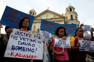 Filipino women hold placards during a Sept. 3, 2016, protest in Manila condemning the bombing at a market in Davao. Experts cite a heightened danger for more than 150 million Catholics and other Christians across South and Southeast Asia following the April 21, 2019, Easter bomb attacks that killed more than 250 people and injured 500. 