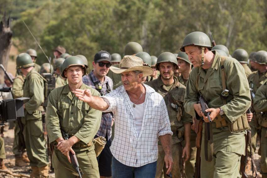 Director Mel Gibson, center, is seen on the set of &quot;Hacksaw Ridge.&quot; The movie marks Gibson&#039;s return to the director&#039;s chair after a 10-year absence.