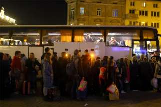 Ukrainian refugees in Przemysl, Poland, wait to board a bus to take them to a temporary shelter March 23, 2022.